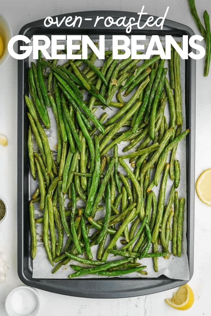 green beans in a baking pan with lemons on the side and text overlay that reads oven roasted green beans