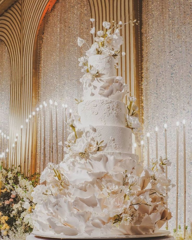 a large white wedding cake sitting on top of a table