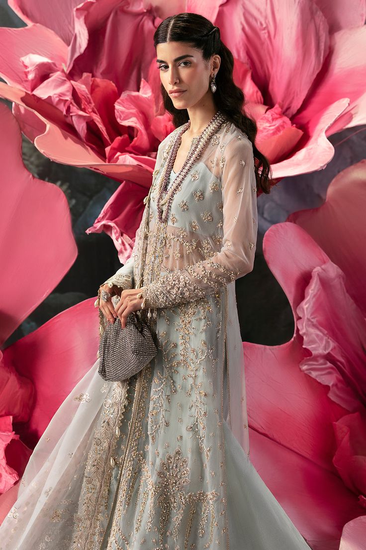 Introducing our elegant aqua three-piece ensemble: a front-open organza A-line shirt hand embellished with intricate cutdana, pearls, baithki, and silver sequins, featuring fitted sleeves for timeless elegance. The heavily embellished panel borders add a modern touch. Paired with raw silk flared sharara and a two-tonal embroidered dupatta. Flared Sharara, Chiffon Collection, Fitted Sleeves, Embroidered Dupatta, Organza Dupatta, Pakistani Dress Design, Pakistani Designers, Wild Flower, Silver Sequin