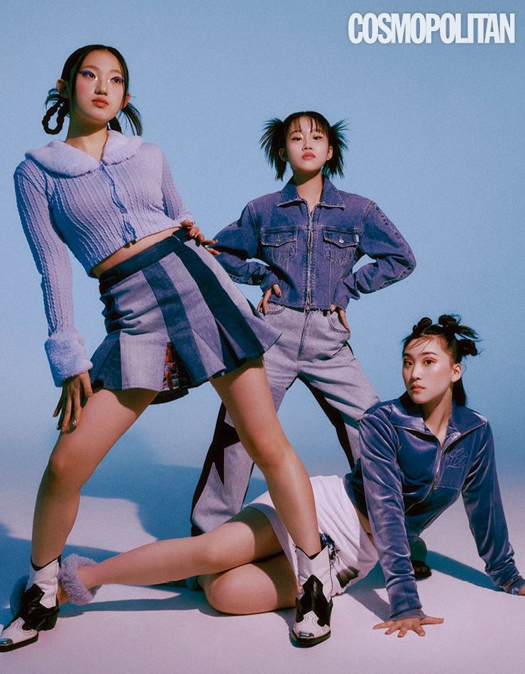 three young women posing in front of a blue background with the words cosmopolian on it