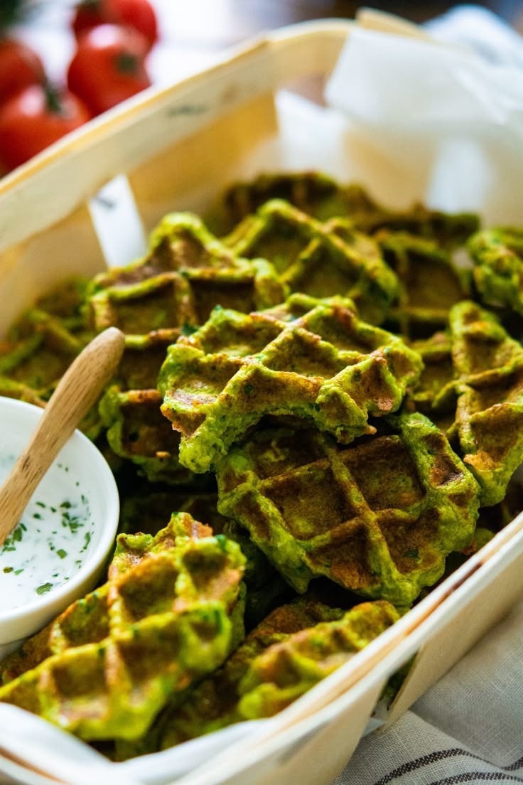 a pan filled with waffles covered in guacamole