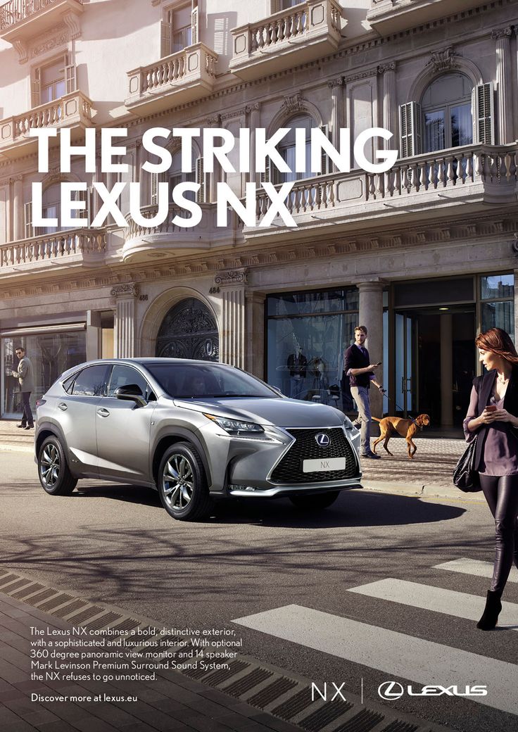 a woman walking across a street next to a silver car in front of a building