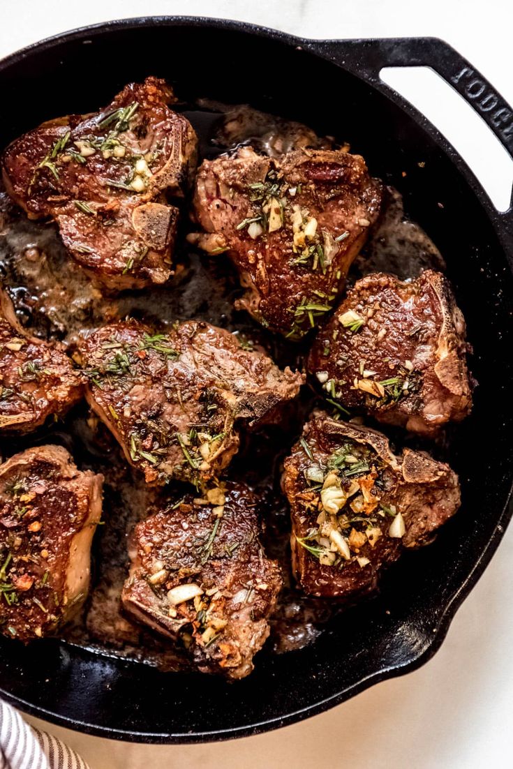 pan seared lamb loin chops in a cast iron skillet with text overlay