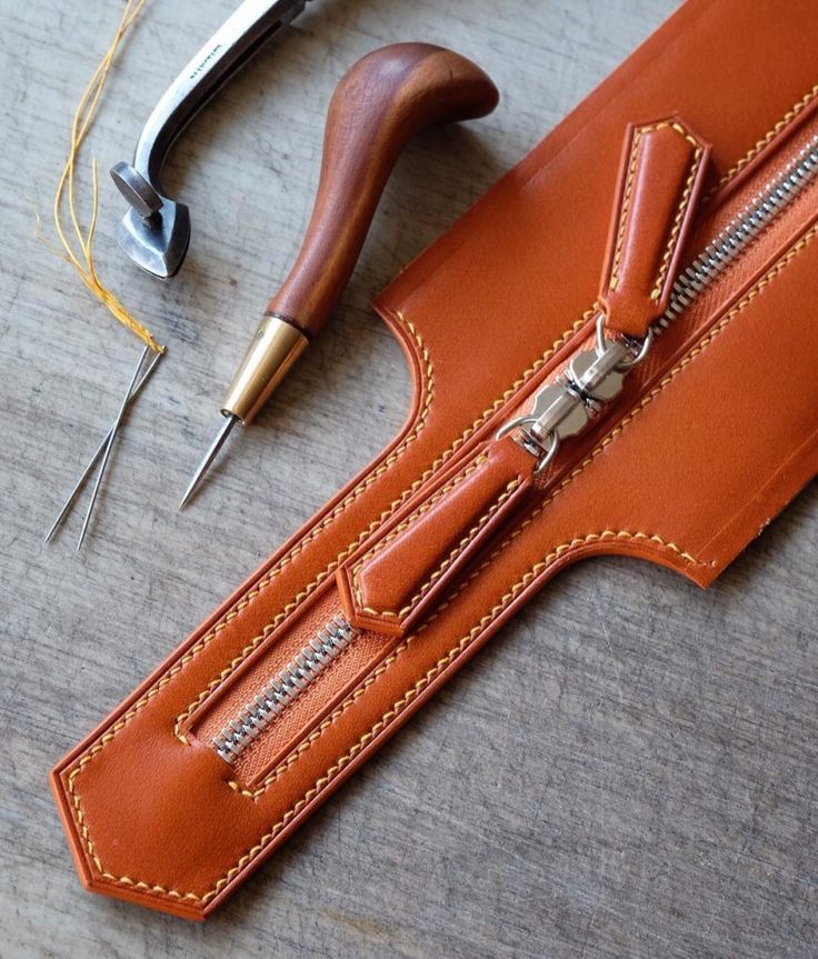 a pair of scissors and some leather material