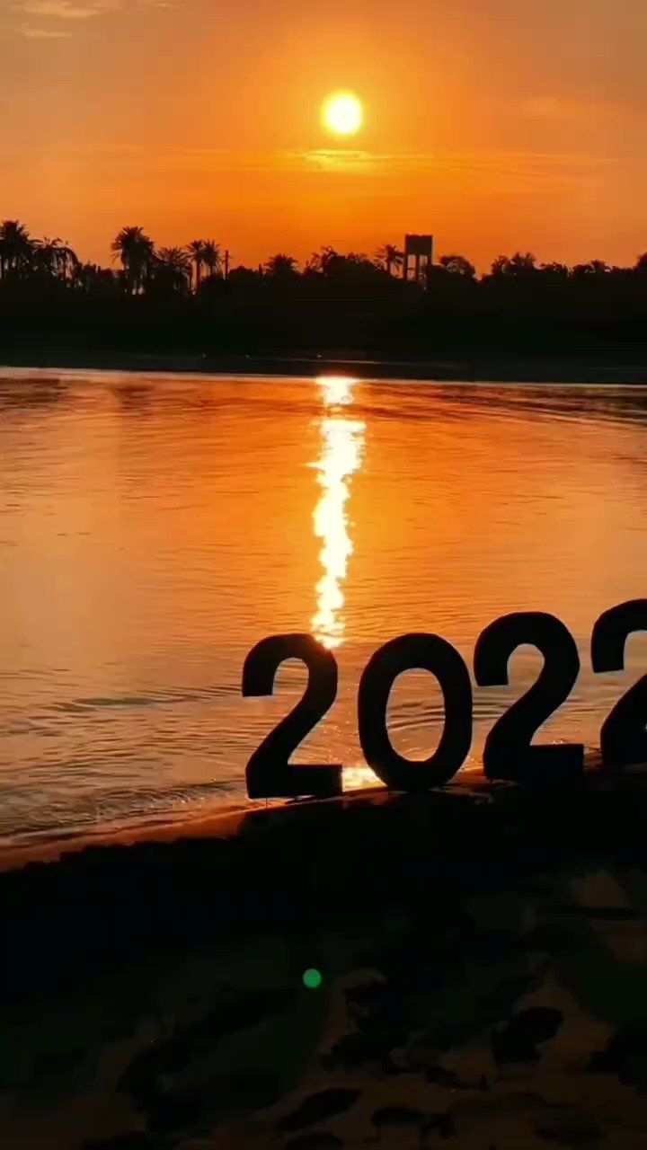 the number twenty two is displayed in front of water at sunset or sunrise, as seen from across the river