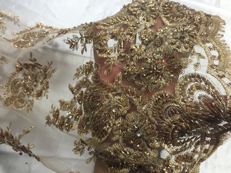 a close up view of the back of a dress with gold sequins on it