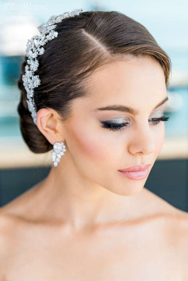 a woman in a wedding dress wearing a tiara