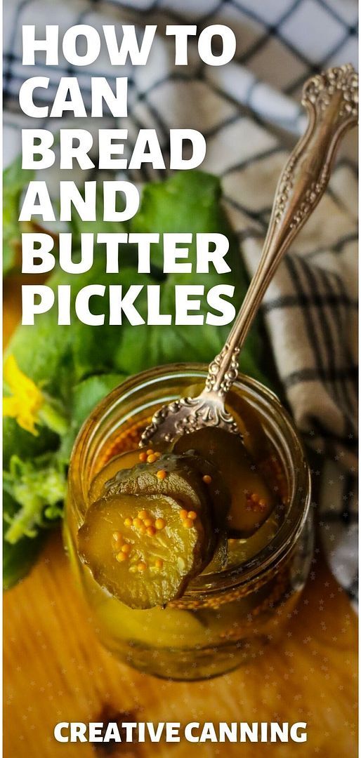 a jar filled with pickles sitting on top of a wooden table