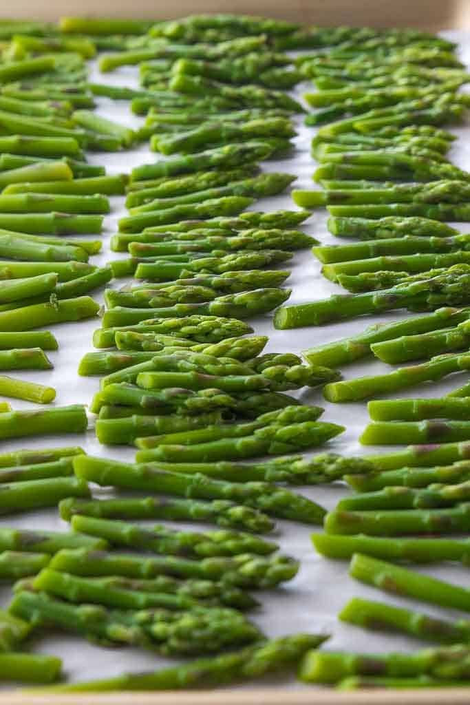 asparagus are being cooked in a pan on the stove top and ready to cook