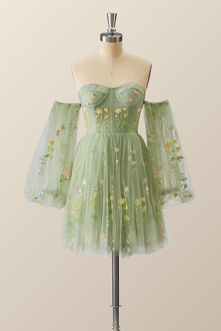 Make a statement in this vibrant, verdant dress! A tulle A-line with floral embroidery, corset bodice, and lacing up the back - it's all topped off with puff-sleeved perfection just above the knee! Hoco Dresses Green Flowy, Homecoming Dresses Cottagecore, Fairy Core Dress Short, Homecoming Dress Inspiration, Spring A-line Corset Dress With Corset Back, Green Dress With Corset Back And Fitted Bodice, Spring A-line Corset Dress With Fitted Bodice, Green Tulle Dress With Corset Back, Green Tulle Dress With Sweetheart Neckline