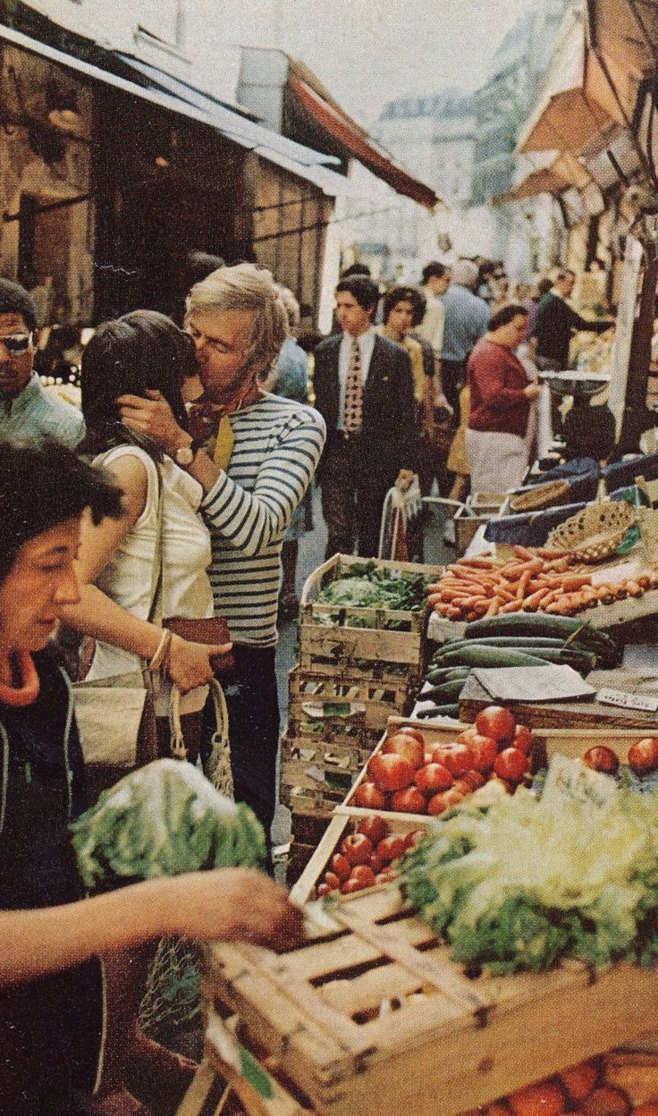 people shopping at an outdoor market with produce