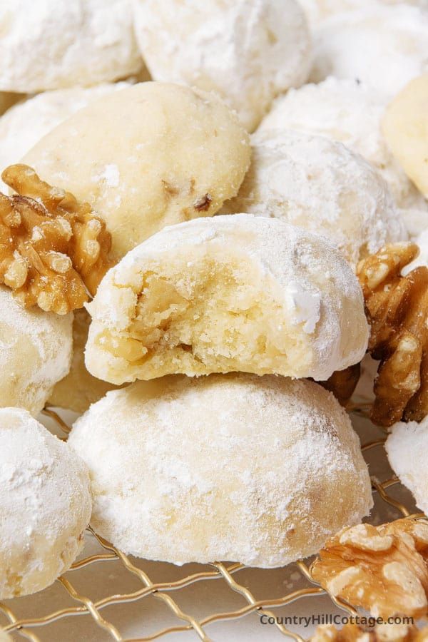 several different types of doughnuts with walnuts on the top and one is cut in half