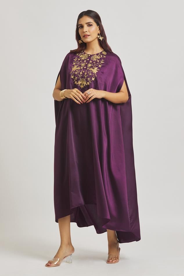 Purple satin dress featuring batwing sleeves and a round neckline, Fit: Relaxed Eid Floral Embroidered Kaftan For Reception, Eid Reception Kaftan With Floral Embroidery, Embroidered Silk Kaftan For Reception, Designer Floor-length Dress With Embroidered Border, Embroidered Kaftan For Eid Reception, Eid Reception Embroidered Kaftan, Anarkali Kaftan With Embroidered Border For Eid, Silk Abaya For Wedding And Festive Occasions, Festive Silk Abaya For Wedding