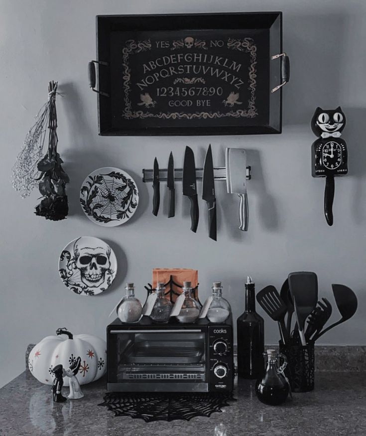 the kitchen counter is covered with black and white plates, utensils, and knives