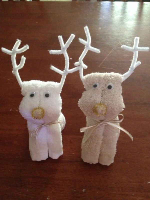 two white stuffed animals sitting on top of a wooden table covered in fake antlers