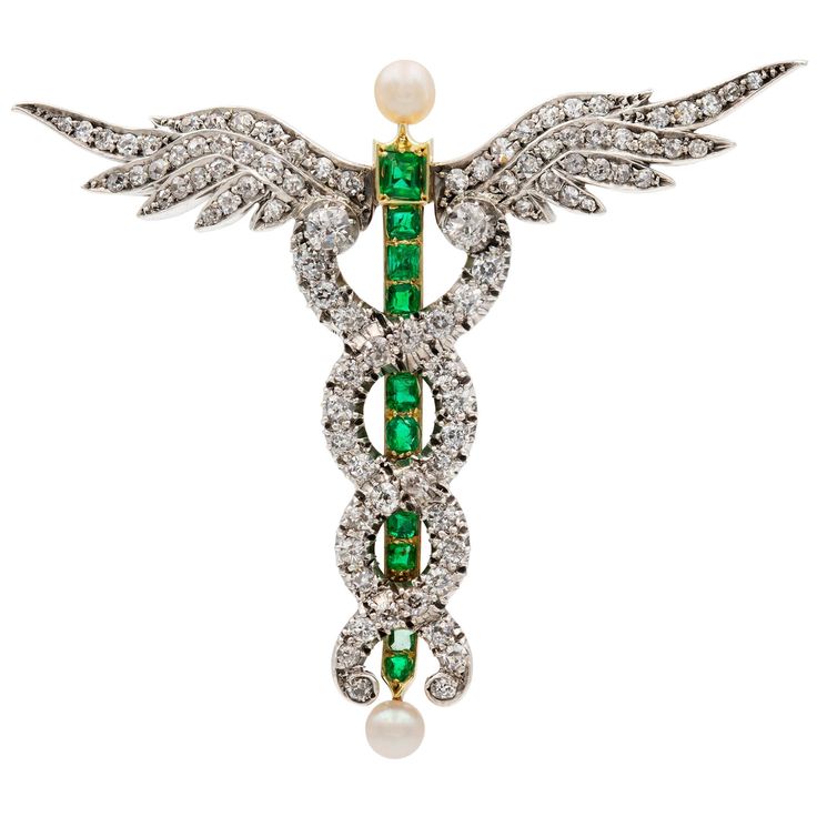 A Victorian diamond, emerald and pearl caduceus brooch, the staff set with ten faceted emeralds estimated to weigh a total of 0.8 carats mounted in 18ct yellow gold, terminating to a round pearl on each end, the entwined serpents and the wings encrusted with old European-cut diamonds estimated to weigh 5.5 carats, mounted in silver to a 18ct yellow gold back, with gold brooch fitting in 9ct yellow gold, circa 1870, measuring approximately 5.5 x 6.4 cm, gross weight 16.6 grams. This antique brooc Green Princess, Dream Gift, Antique Brooches, Diamond Brooch, Gold Brooches, Green Diamond, Bespoke Jewellery, Pearl Brooch, European Cut Diamonds