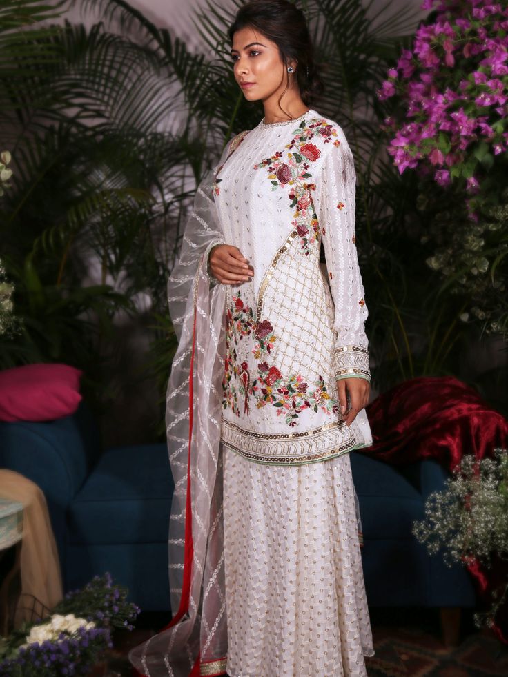 This white thread embroidered kameez is intricately detailed with multi-hued French knots, sequins and pearls.  It is teamed with palazzo pants and a matching dupatta. Suites Designs, Punjabi Salwar, Embroidered Suit, Excel Formula, Indo Western Dress, Eid Dresses, Punjabi Salwar Suits, French Knots, Sharara Set