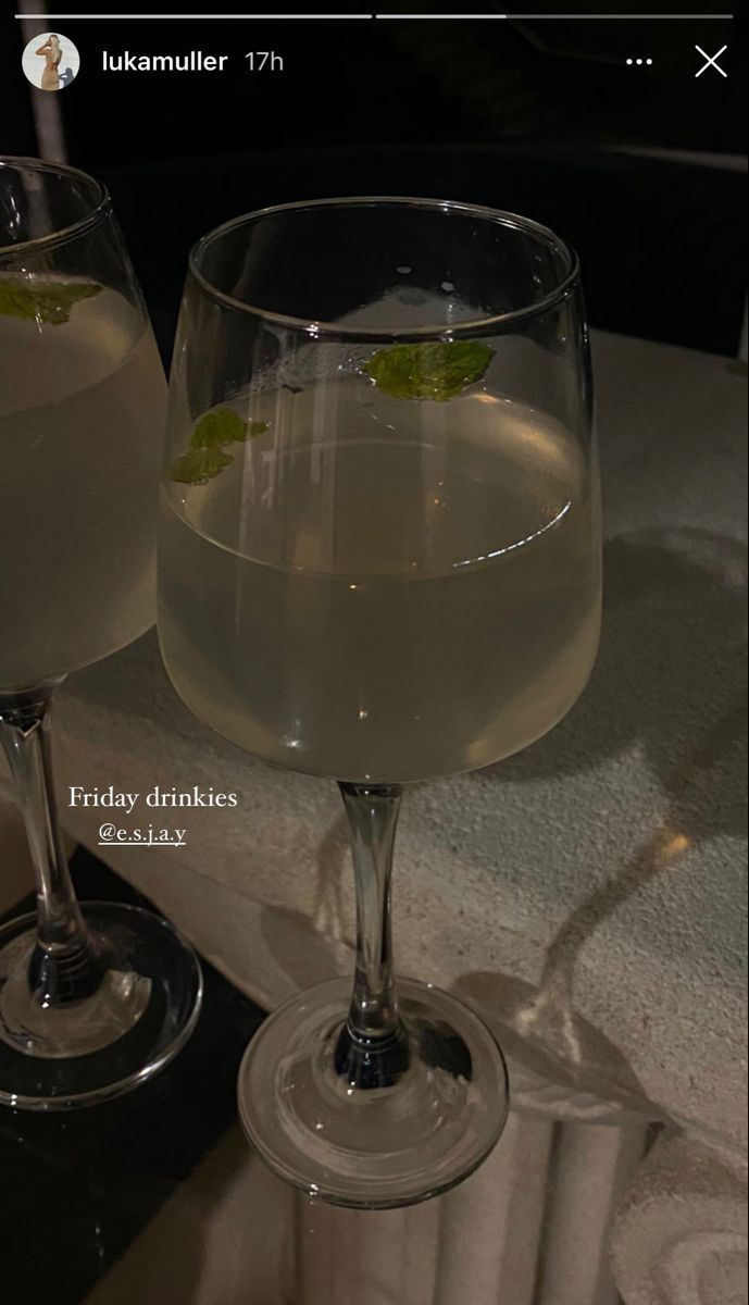 two glasses filled with liquid sitting on top of a table