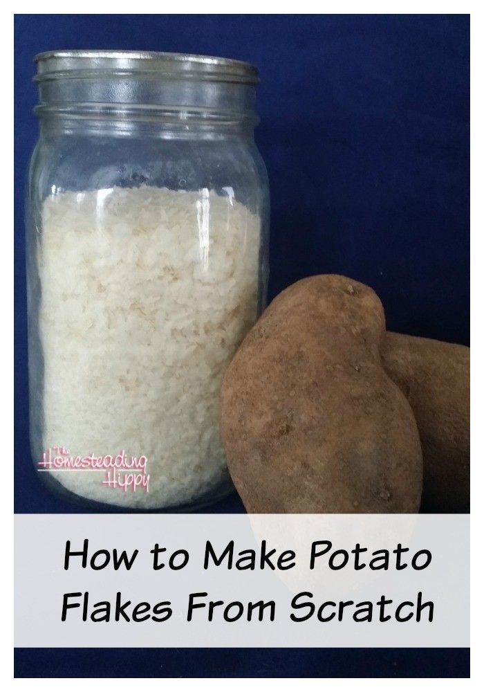 a jar filled with white stuff next to a potato