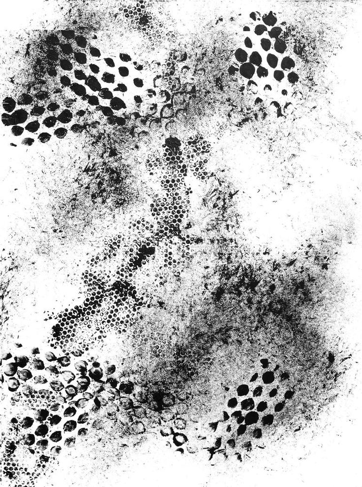 black ink splattered on white paper with circles and dots in the center, including one