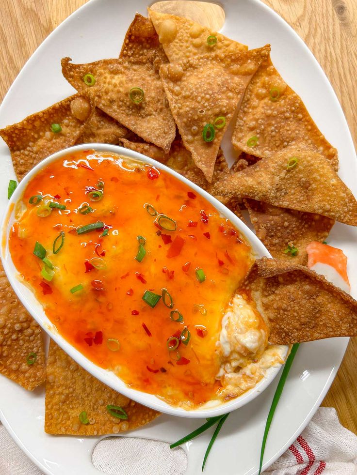 a white plate topped with tortilla chips and dip