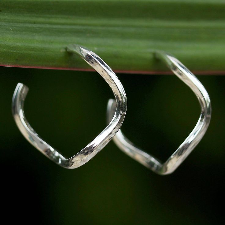 Celebrating the ingenuity of Thai artisans, Pichaya presents this wonderful pair of half-hoop earrings. Bringing a modern touch to any jewelry collection, the earrings are crafted of sterling silver with a high-polish finish, featuring twisting bars that extend behind the ears. Modern Twist Polished Hoop Earrings As Gift, Modern Twist Hoop Earrings As Gift With Polished Finish, White Gold Hoop Earrings With Modern Twist, Modern Twist White Gold Hoop Earrings As Gift, Modern Twist Sterling Silver Hoop Earrings, Modern Twist Huggie Earrings As Gift, Modern Twist Huggie Earrings For Gifts, Modern Twist Sterling Silver Hoop Earrings For Pierced Ears, Modern Twist Sterling Silver Hoop Earrings Gift