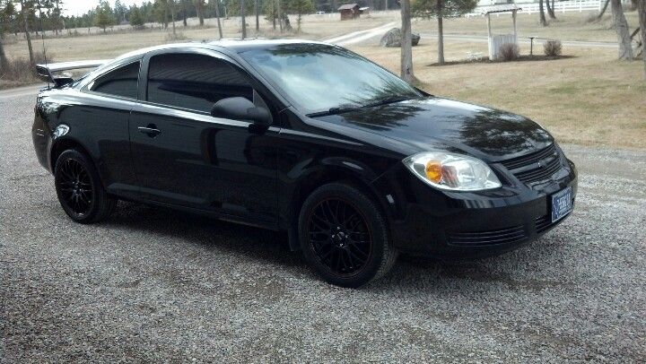 a black car parked on the side of a road