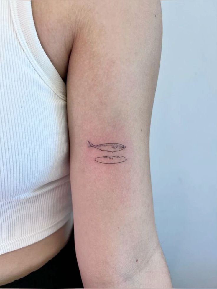 a woman's arm with a small tattoo on the left side of her body