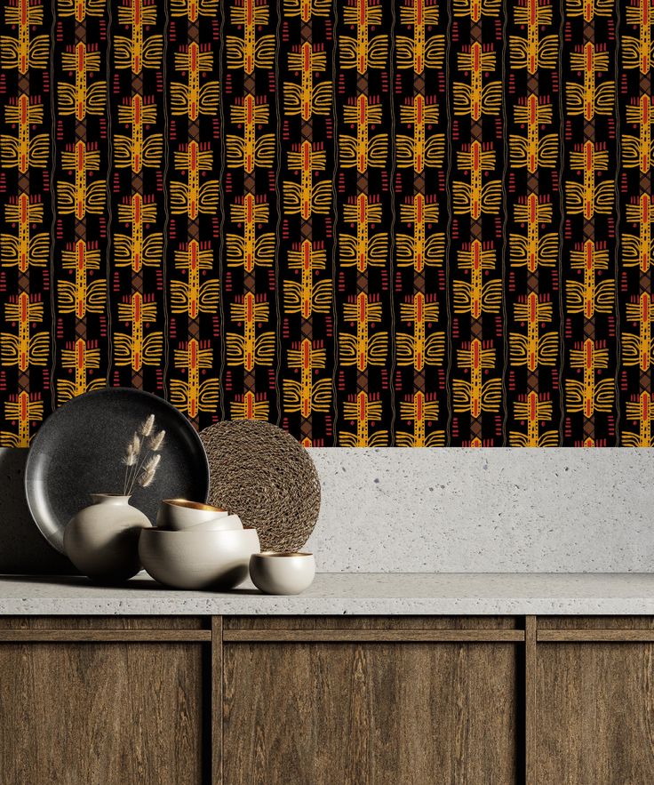 a kitchen counter with plates and bowls on it next to a wallpapered background