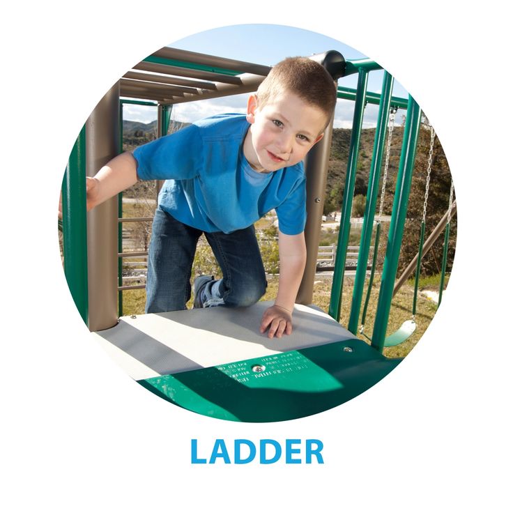 a young boy climbing up the side of a slide