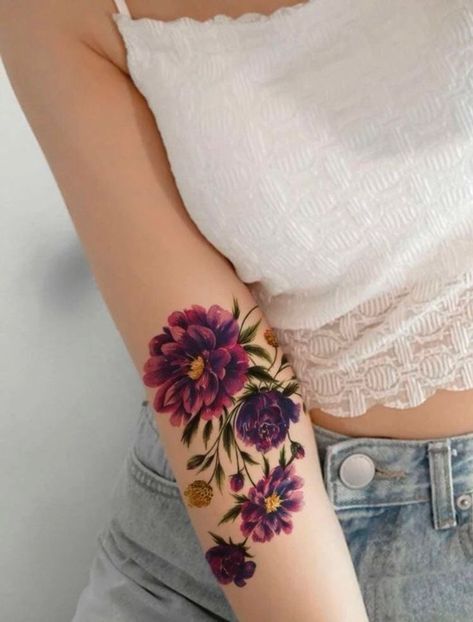 a woman with a flower tattoo on her arm