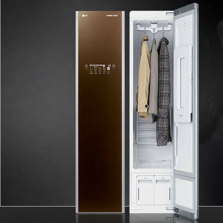 an open refrigerator with clothes hanging in it