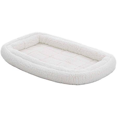 a dog bed that is white and fluffy