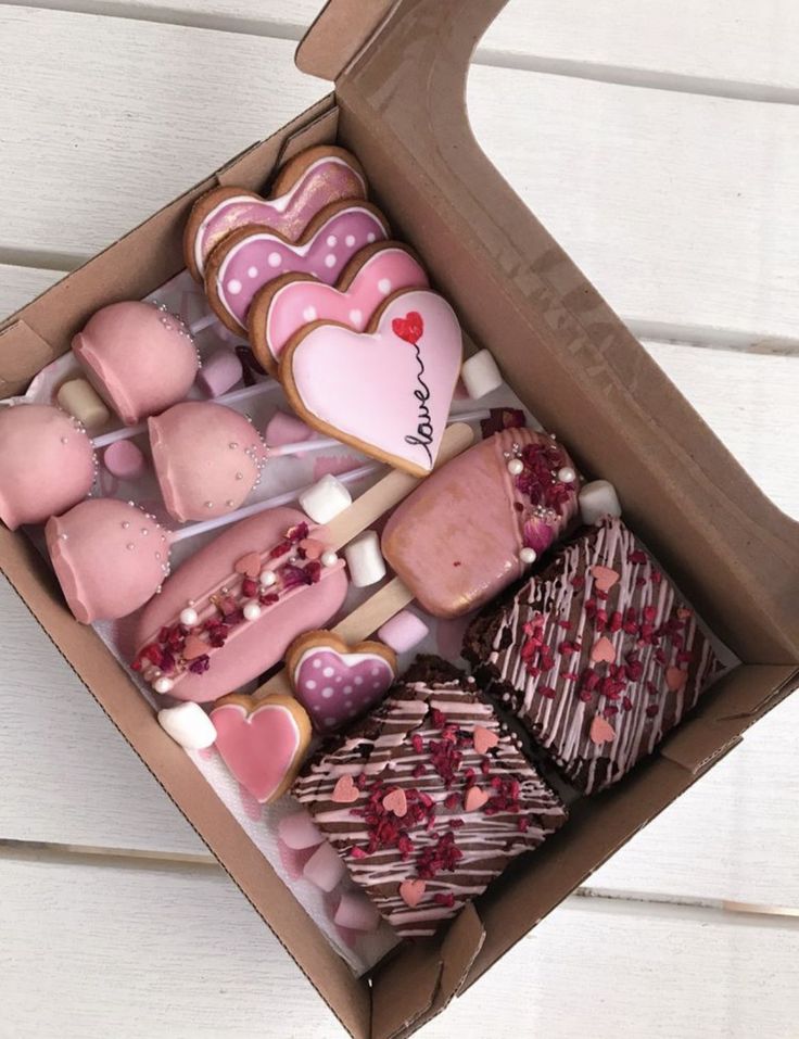 a box filled with lots of heart shaped cookies