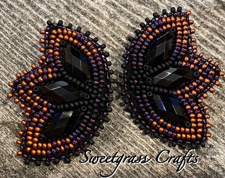 two pieces of beaded jewelry sitting on top of a table