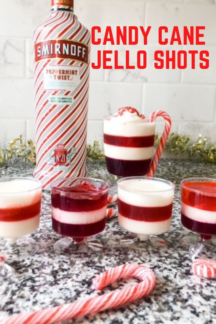 candy cane jello shots in front of a bottle with candy canes around it