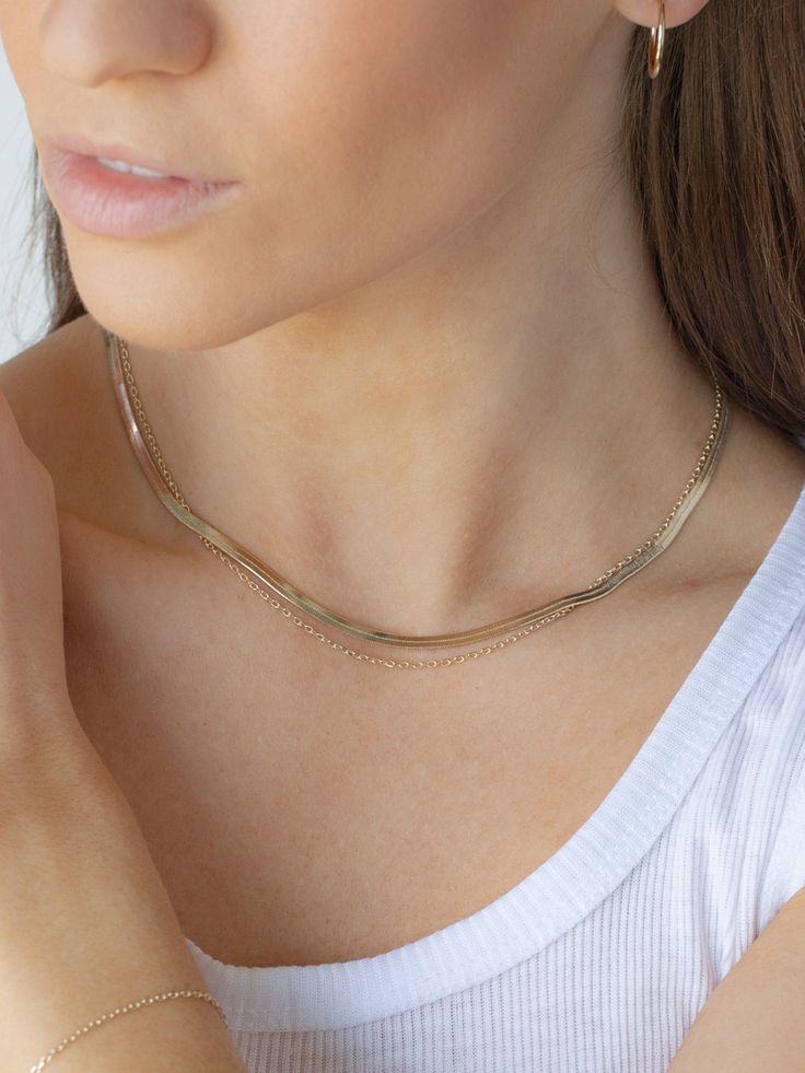 Dress up any outfit with this sophisticated layered necklace set. The outside necklace is thick and has incredible shine while the inside layer features a chain necklace. Both necklaces are attached to the same clasp to prevent tangling and help save time when getting dressed. This layered necklace set complements the layered bracelet set and creates the ultimate stylish look. - Brass with Polyurethane Coating- Available in Gold and Silver Elegant Multi-strand Layered Chain Necklace, Elegant Layered Multi-strand Chain Necklace, Minimalist Multi-strand Clavicle Chain Necklace, Elegant Gold Snake Chain Choker, Layered Double Strand Minimalist Jewelry, Minimalist Layered Double Strand Jewelry, Multi-strand Gold Chain Necklace For Layering, Multi-strand Double Chain Jewelry For Gifts, Elegant Multi-strand Double Chain Necklace