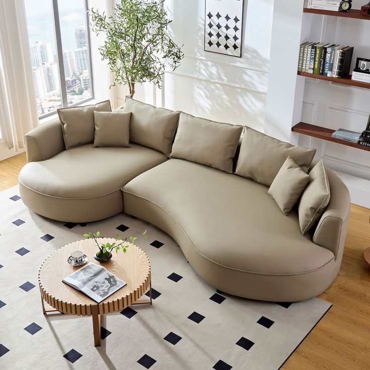 a large sectional couch sitting on top of a white rug in a living room next to a coffee table