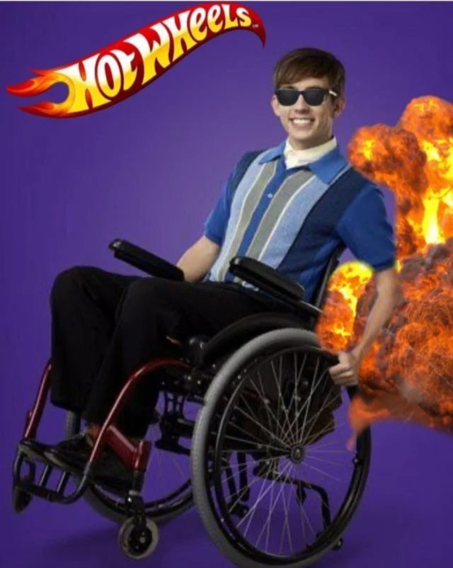 a man in a wheel chair with flames behind him