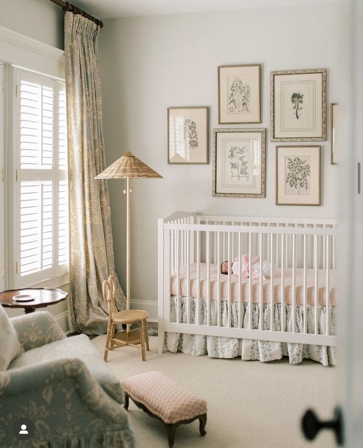 a baby's room with pictures on the wall and a crib in the corner