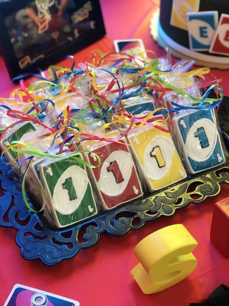 a table topped with blocks and toys on top of a red table cloth covered in confetti