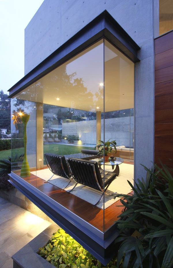 a modern house with glass walls and wooden flooring