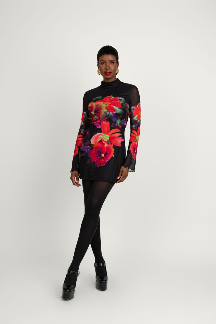 Miranda is the ultimate mini dress. Featuring a captivating all-over large romantic flower print and an A-line silhouette for a breezy flattering shape. This is the piece that you'll want to flaunt at special occasions this winter. Cut in sheer mesh fabric, it showcases long sleeves with stylishly flared cuffs and a short turtleneck collar. Pair this garment with your favorite high-heeled boots and our Nadia coat to top off the look. Long Sleeve Floral Dress For Party, Long Sleeve Floral Print Party Dress, Spring Evening Long Sleeve Floral Dress, Spring Evening Floral Long Sleeve Dress, Long Sleeve Sheer Mini Dress For Fall, Winter Evening Dress With Floral Print, Fitted Floral Print Mini Dress For Winter, Christmas Party Fits, Chic Winter Mini Dress With Floral Print