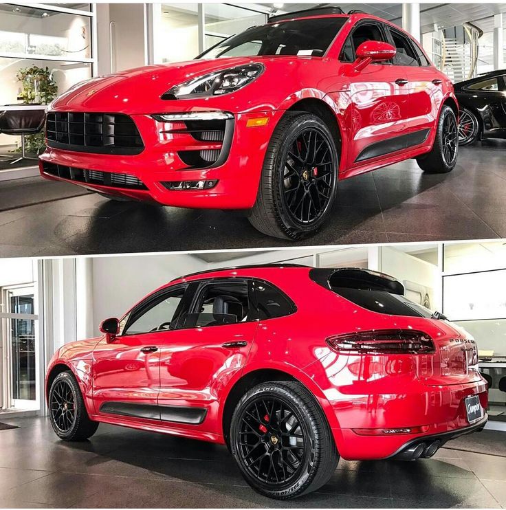 the red porsche cayenne is parked in a showroom