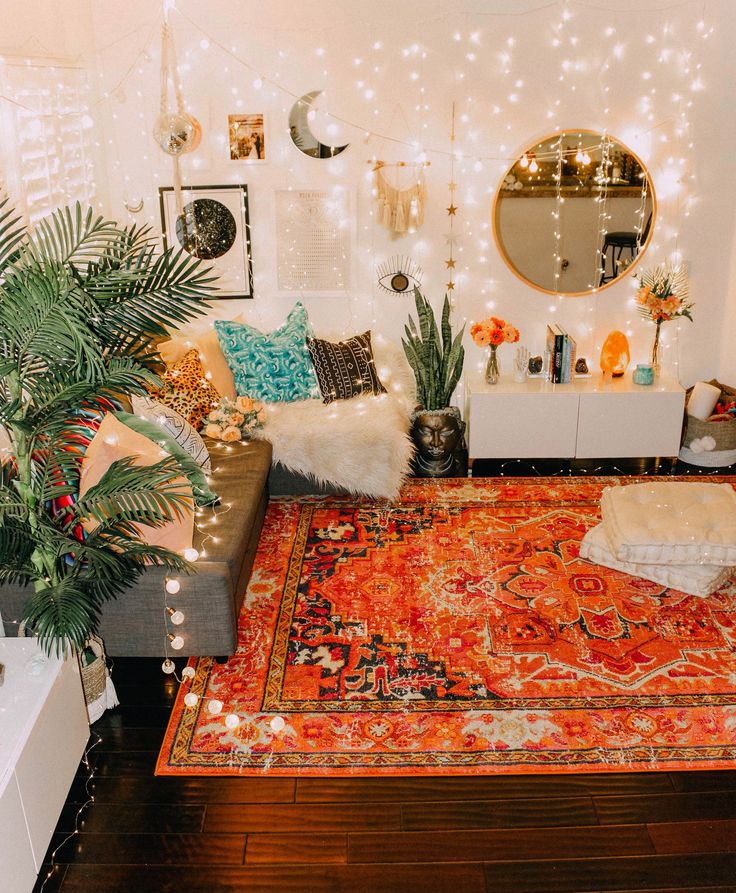 a living room filled with lots of furniture and decor on top of a wooden floor