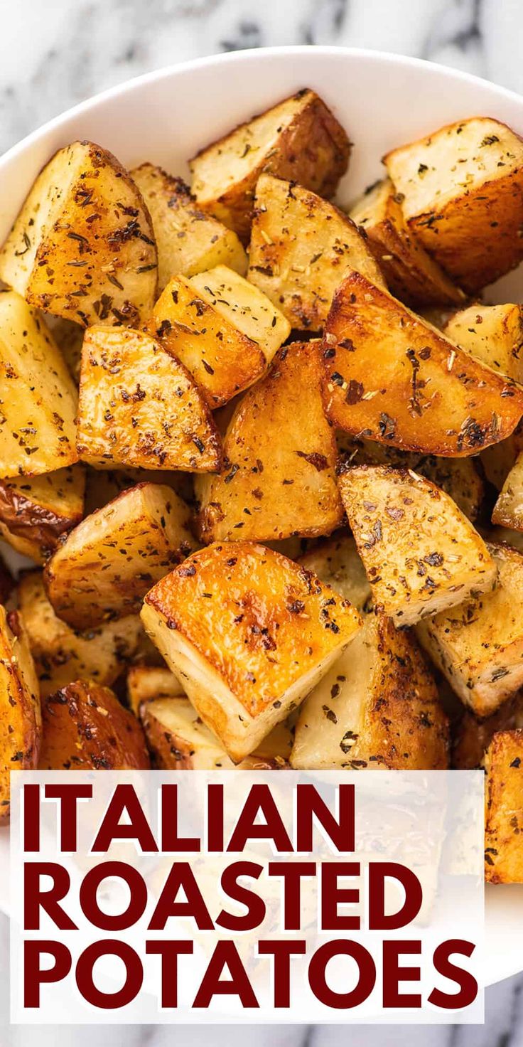 a white bowl filled with roasted potatoes on top of a marble counter next to the words italian roasted potatoes