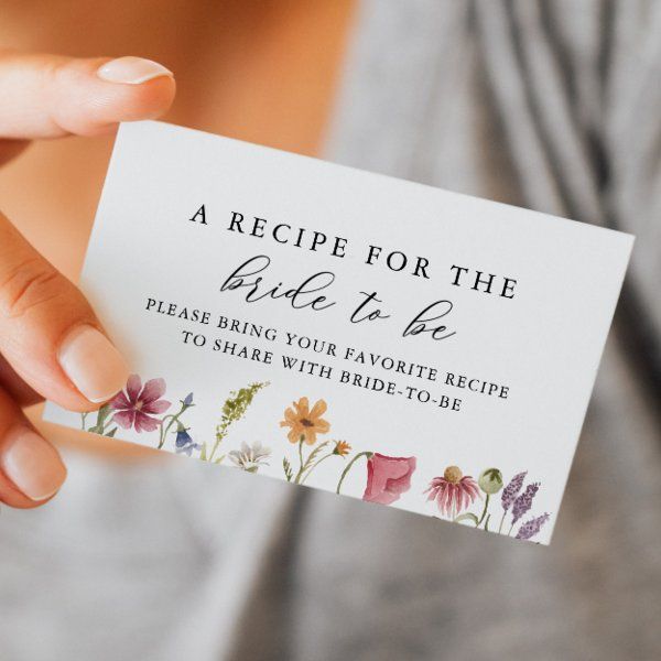 a woman holding up a card with flowers on it that says recipe for the bride to be