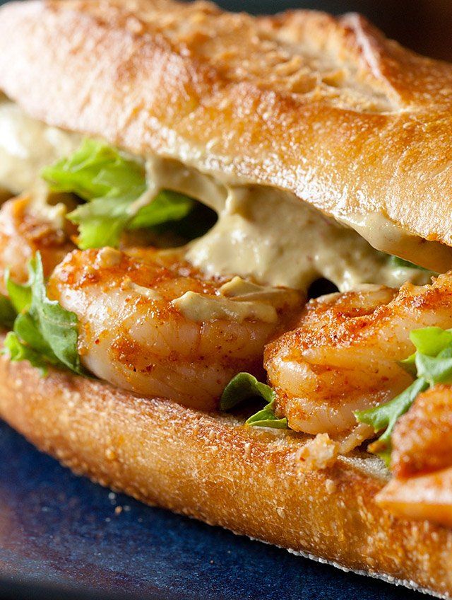 there is a sandwich with shrimp and lettuce on it