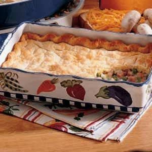 a casserole dish with vegetables in it on a table next to other dishes