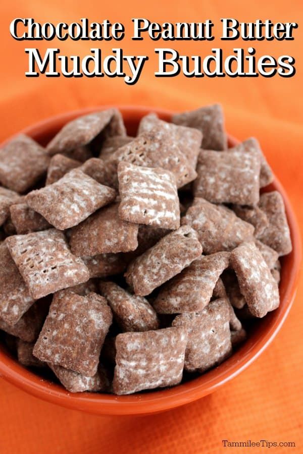 chocolate muddy buddies in a white bowl on top of a red and orange table cloth